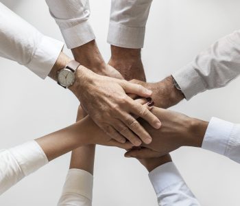 business-hands-joined-together-teamwork-scaled.jpg